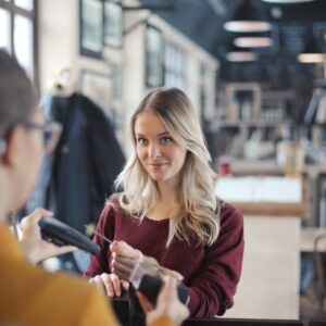 young-woman-pays-by-credit-card-restaurant_641386-418