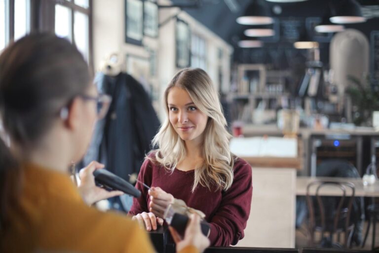 young-woman-pays-by-credit-card-restaurant_641386-418
